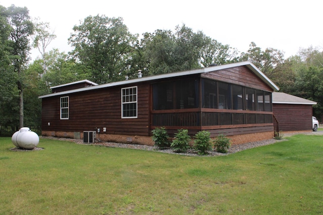 view of home's exterior featuring a yard, crawl space, a sunroom, and central air condition unit