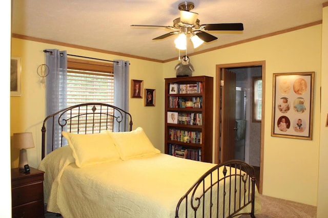 bedroom featuring carpet, ornamental molding, and a ceiling fan