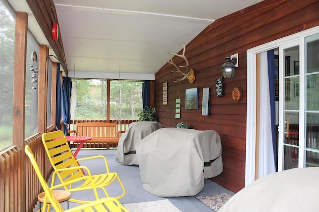 sunroom / solarium featuring lofted ceiling