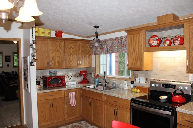 kitchen with a textured ceiling, a sink, brown cabinets, decorative backsplash, and stainless steel electric range oven