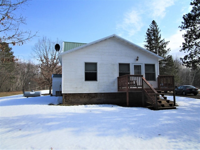 view of front of home with stairs and a deck