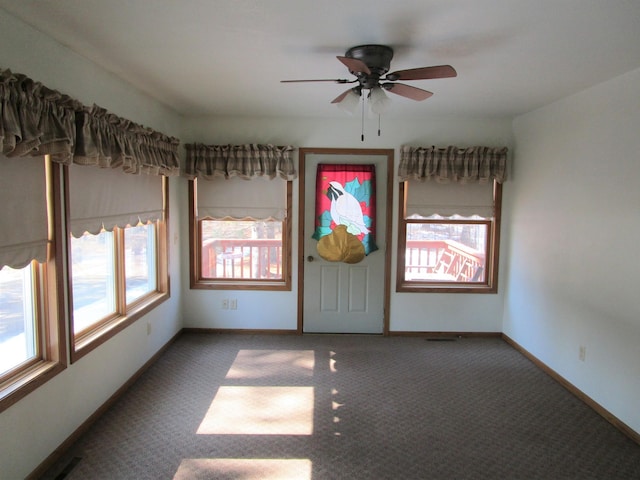 empty room featuring carpet floors, visible vents, and baseboards