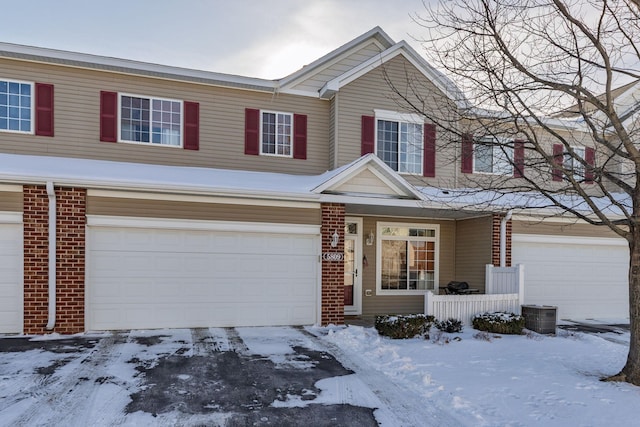 view of property with brick siding and an attached garage