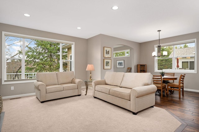 3595 Lemieux Cir, Eagan, MN 55122 - living area with baseboards, recessed lighting, arched walkways, a chandelier, and hardwood / wood-style flooring