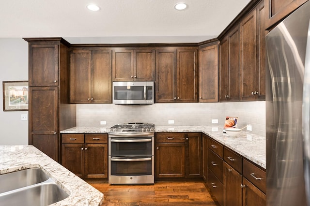 3595 Lemieux Cir, Eagan, MN 55122 - kitchen with appliances with stainless steel finishes, dark wood finished floors, dark brown cabinets, backsplash, and recessed lighting