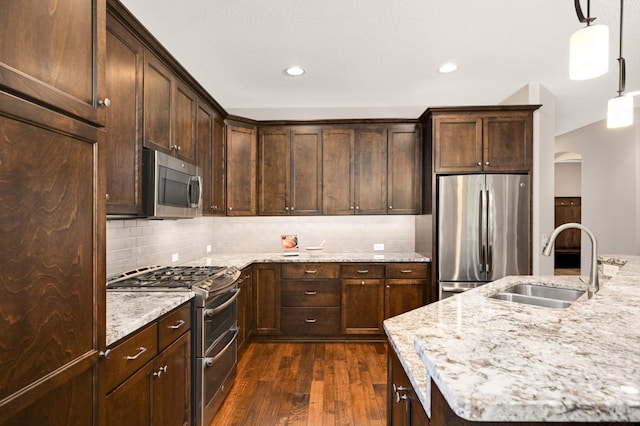 3595 Lemieux Cir, Eagan, MN 55122 - kitchen featuring stainless steel appliances, a sink, dark wood-type flooring, dark brown cabinetry, and backsplash