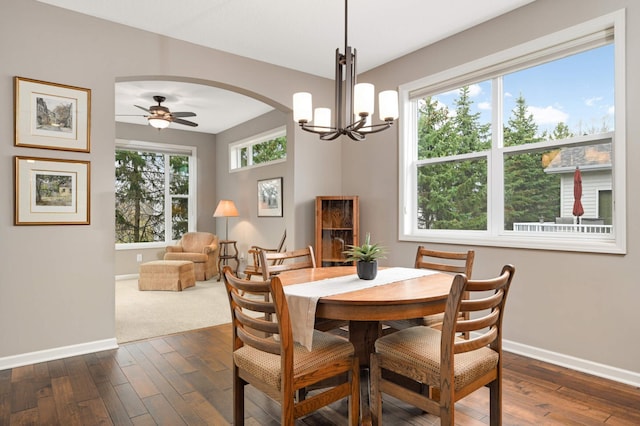 3595 Lemieux Cir, Eagan, MN 55122 - dining room with baseboards, dark wood-style floors, arched walkways, and a chandelier