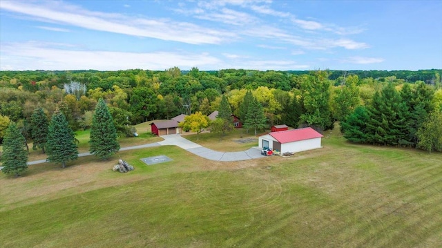 drone / aerial view featuring a wooded view