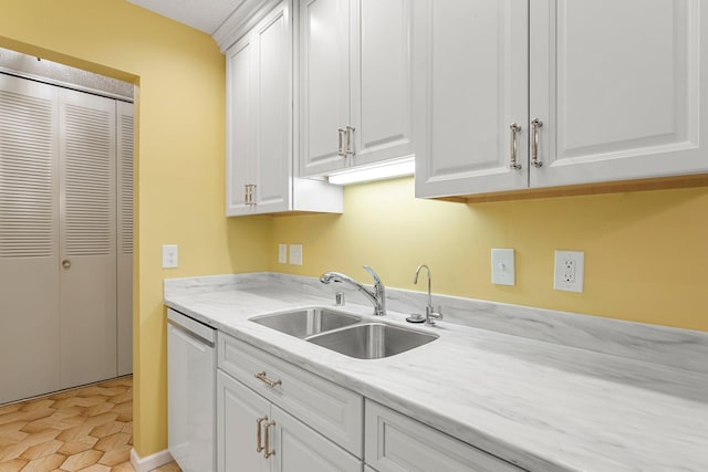 kitchen with dishwashing machine, a sink, and white cabinets