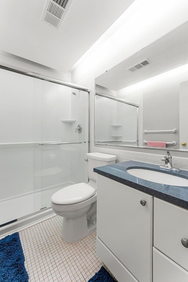 full bathroom featuring a stall shower and visible vents