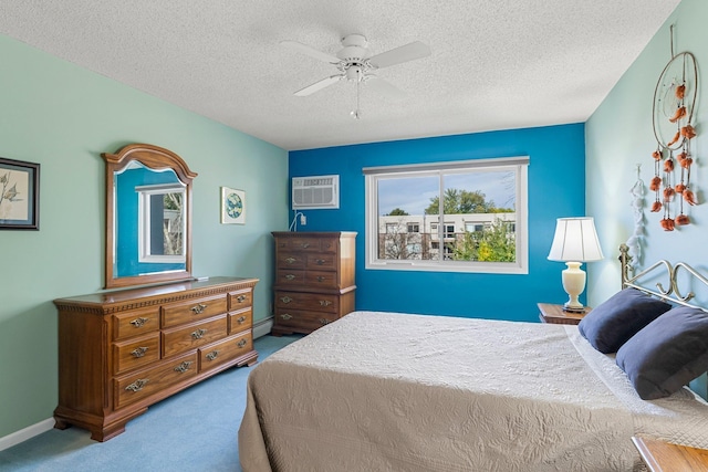 carpeted bedroom with a baseboard heating unit, an AC wall unit, ceiling fan, and a textured ceiling