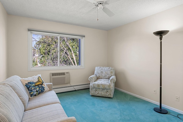 interior space featuring a baseboard heating unit, an AC wall unit, a textured ceiling, and a ceiling fan