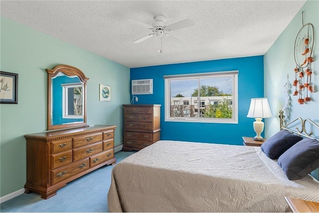 bedroom featuring ceiling fan, a textured ceiling, carpet flooring, an AC wall unit, and a baseboard heating unit