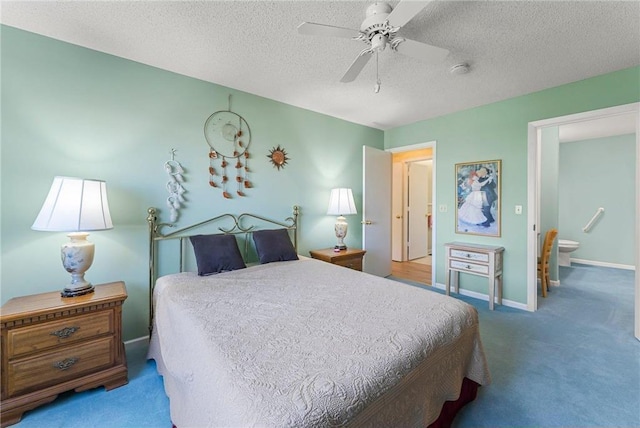 carpeted bedroom with ceiling fan, connected bathroom, baseboards, and a textured ceiling