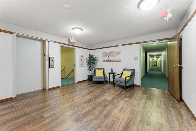 living area featuring a textured ceiling and wood finished floors