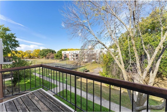 wooden deck featuring a lawn