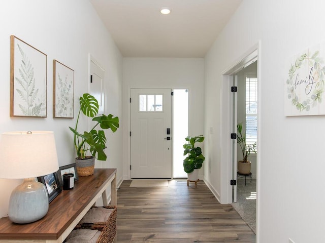 foyer with baseboards, wood finished floors, and recessed lighting