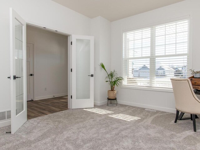 home office with plenty of natural light, french doors, carpet, and visible vents