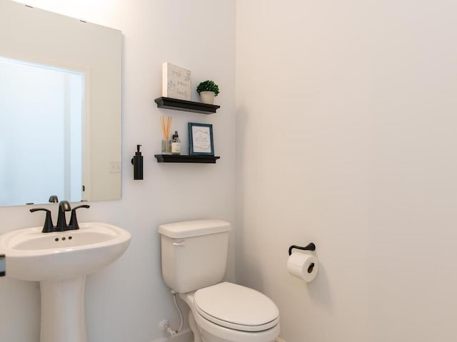 half bathroom with a sink and toilet