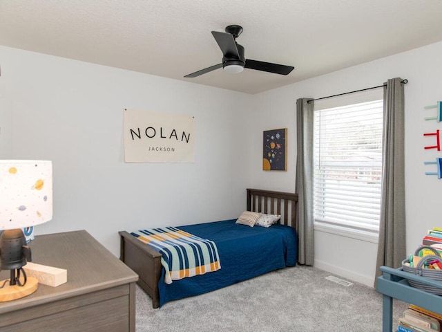 bedroom with carpet, a ceiling fan, and baseboards