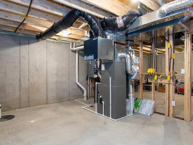 unfinished basement featuring heating unit