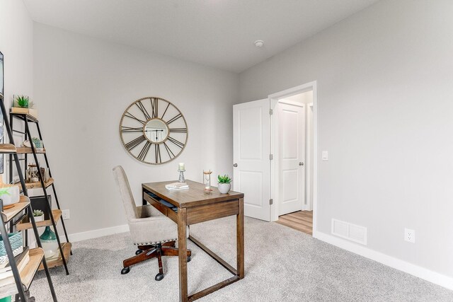 office area with carpet, visible vents, and baseboards