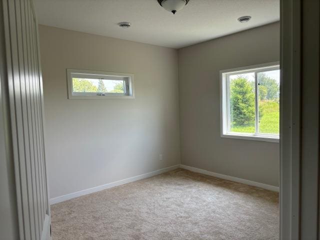 carpeted spare room with baseboards