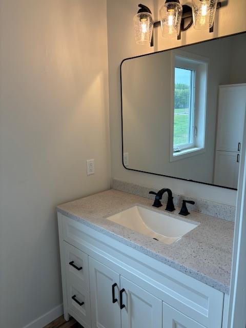 bathroom featuring baseboards and vanity