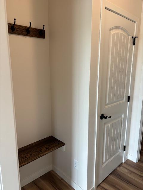 mudroom with baseboards and wood finished floors