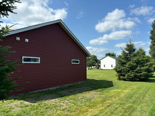 view of side of home featuring a yard