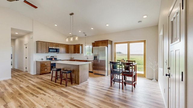 619 6th St, West Concord, MN 55985 - kitchen with appliances with stainless steel finishes, a center island, light countertops, light wood-style flooring, and recessed lighting