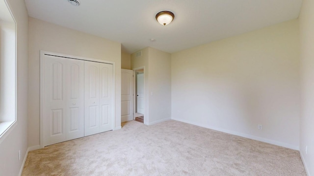 619 6th St, West Concord, MN 55985 - unfurnished bedroom featuring carpet flooring, a closet, and baseboards