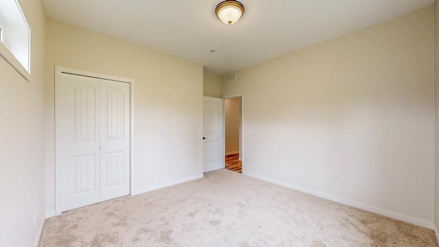 619 6th St, West Concord, MN 55985 - unfurnished bedroom with carpet, a closet, and baseboards