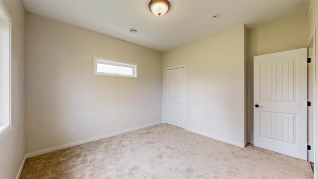 619 6th St, West Concord, MN 55985 - unfurnished bedroom with carpet, baseboards, and a closet