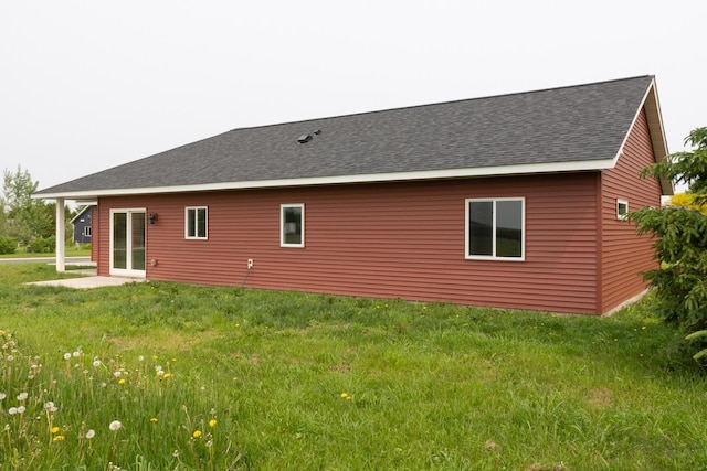 619 6th St, West Concord, MN 55985 - back of property with a shingled roof and a lawn
