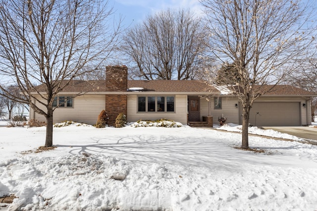 ranch-style home with a chimney and an attached garage