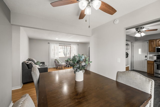 dining space with wood finished floors and baseboards