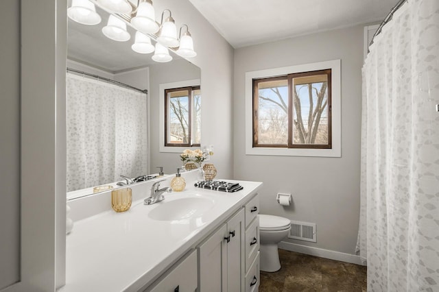 full bathroom featuring vanity, baseboards, visible vents, toilet, and a chandelier