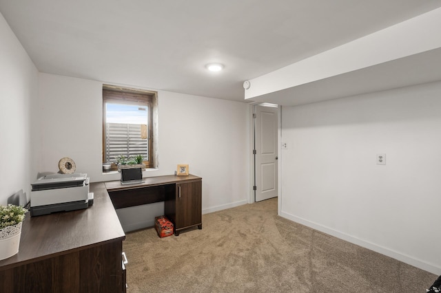 home office featuring baseboards and light carpet