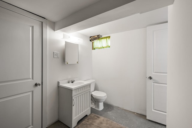 bathroom with toilet, concrete flooring, and vanity