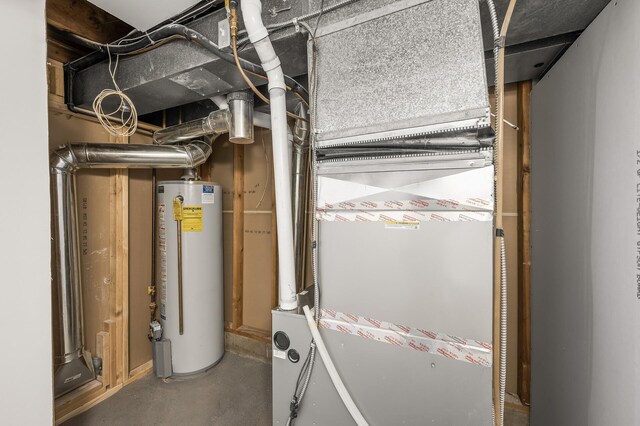 utility room featuring water heater