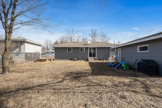 back of property with entry steps and fence