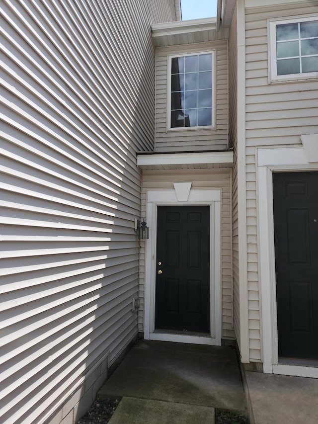 doorway to property with a garage