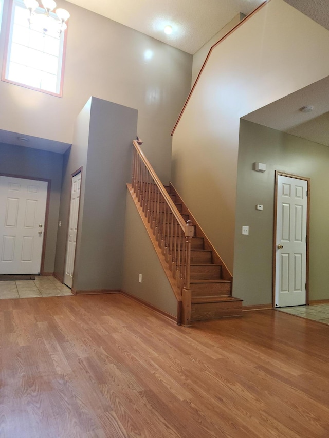 7721 Elm Grove Ave, New Hope, MN 55428 - foyer featuring a high ceiling, wood finished floors, stairs, and baseboards