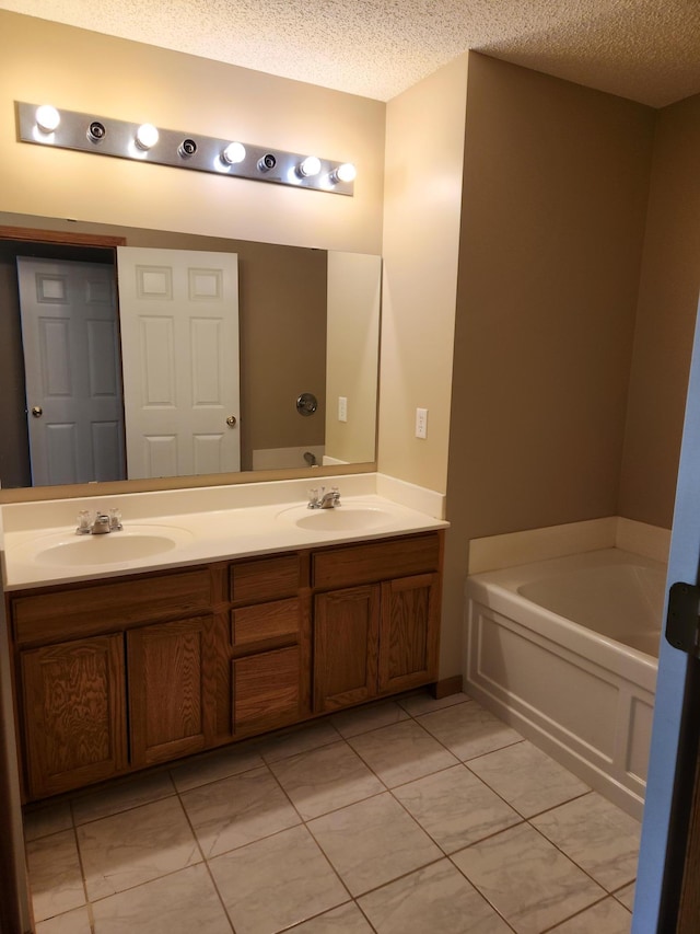 7721 Elm Grove Ave, New Hope, MN 55428 - bathroom with double vanity, a textured ceiling, and a bath