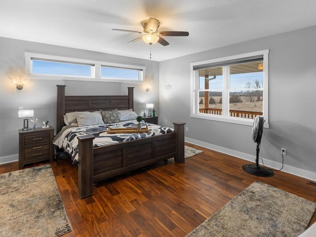 bedroom featuring dark wood finished floors and baseboards