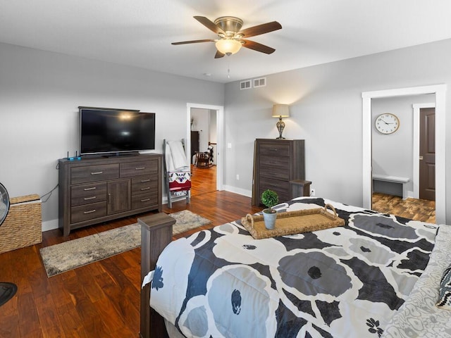 bedroom with ceiling fan, dark wood-style flooring, visible vents, and baseboards