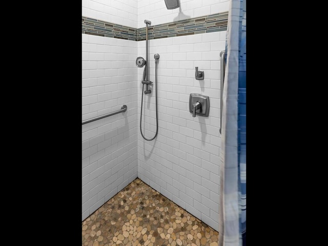 full bathroom with tiled shower