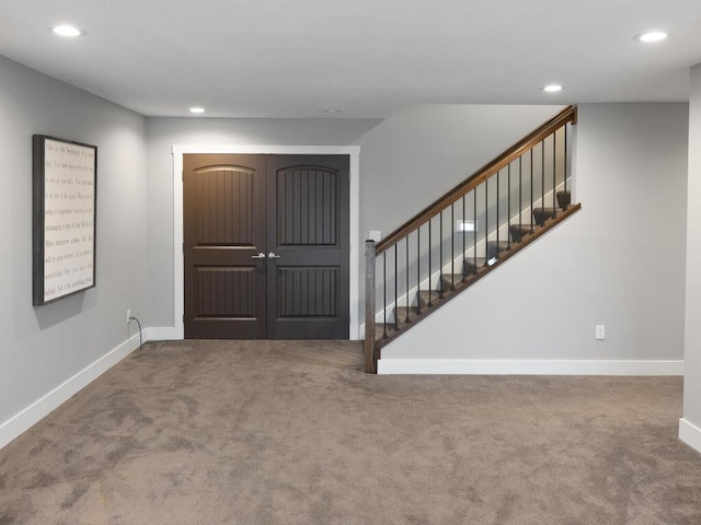 foyer entrance with stairs, carpet, baseboards, and recessed lighting