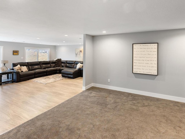 living area featuring carpet, baseboards, and recessed lighting